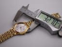 Seiko watch being measured by a digital caliper, displaying a case size of 32.70mm.