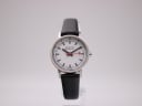 Front view of the Mondaine 3831 watch with white dial, silver case, and black leather strap on a stand.