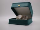 Tissot Ballade watch presented in its original dark green presentation box, adorned with a distinctive gold crown emblem.