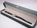 The vintage Tissot watch presented inside its original green Tissot presentation box, with the strap laid neatly.