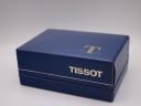 Closed original Tissot watch box with gold Tissot logo on the lid and a gold trim line.