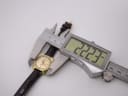 Digital caliper measuring the Tissot watch case diameter at precisely 22.23mm.