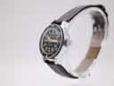 Angled side view of the CASWATCH watch, highlighting the silver case, rotating black bezel, and crown.