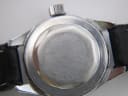 Close-up of the CASWATCH watch's stainless steel case back, with "WATER RESISTANT 5 ATM SINGLE TESTED SWISS MADE STAINLESS STEEL BACK BASE METAL BEZEL" engraving.