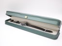 The CASWATCH watch nested inside its original long, green presentation box with cream interior.