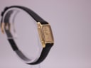Angled view of the Raymond Weil watch on a display stand, showing the other side profile.