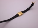 Rear view of the Raymond Weil watch, showing the case back and the full length of the black leather strap.