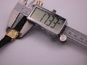 Digital caliper measuring the Raymond Weil watch case, displaying a width of 17.33mm.