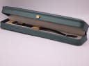 The Raymond Weil watch resting inside its original dark green presentation box with a cream interior.