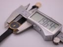 Digital caliper measuring the Raymond Weil watch case, displaying a precise diameter of 19.64mm.