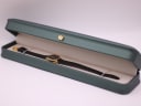 The Raymond Weil 570 watch presented inside its original dark green rectangular box with a cream interior.