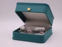 The Emporio Armani AR-1781 watch nestled in its original teal-coloured presentation box with a golden crown emblem.