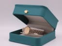 The Tissot watch displayed inside its original teal-coloured presentation box with a gold crown emblem.
