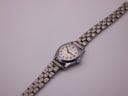 Overhead view of the Jaquet-Droz watch laid flat, displaying the full steel bracelet.