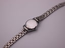 Back view of the Jaquet-Droz watch showing the brushed steel case back and the integrated bracelet.