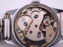 Detailed close-up of the Jaquet-Droz 17 jewel mechanical movement, showing "UNADJUSTED SWISS" inscription.