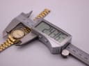 Digital caliper measuring the watch case diameter at 24.36mm.