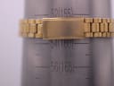 Close-up of the gold-tone Seiko bracelet clasp on a wrist sizing gauge, indicating a wrist size of approximately 155mm.