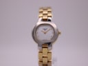 Front view of the Tissot G330 ladies' watch, two-tone case, white dial, gold hands, and gold steel bracelet.