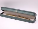 The Tissot G330 watch resting inside its original dark green presentation box with a cream interior.