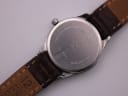 Detailed view of the Favre Leuba watch case back, showing model number 24G0-42, 3 ATM water resistance, and 'stainless steel back base metal swiss made quartz'. The strap also shows '12 genuine leather'.