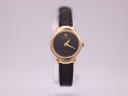 Front view of a vintage Raymond Weil 5827 ladies watch with a gold electroplated tonneau case, black textured dial, and black leather strap.