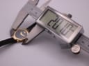 Photo showing a digital caliper measuring the case width of the Raymond Weil watch, displaying an exact measurement of 20.07mm.