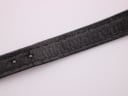 Close-up of the black leather strap, displaying its crocodile grain texture and some signs of wear and creasing.