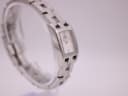 Another angled side view of the Tissot watch on a stand, highlighting the bracelet links.