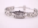 Front view of the Tissot watch laid flat, displaying the white dial and integrated steel bracelet.
