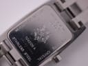 Detailed close-up of the stainless steel case back with Tissot logo, model number T042109 A, serial number and 'sapphire crystal' engraving.