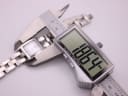 Digital caliper measuring the Tissot watch case, showing an exact reading of 18.64mm.