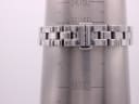Close-up of the Tissot watch's integrated bracelet clasp on a wrist sizing gauge, indicating a wrist size of 160mm, with Tissot logo.