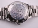 Close-up of the stainless steel case back, showing "Citizen Watch Co." "Water Resistant" and model/serial numbers.