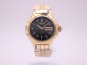 Front view of vintage gold-toned Seiko 2206-0090 automatic watch with black dial and day-date display.