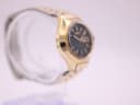 Left side profile of the gold-toned Seiko cushion case and integrated bracelet.
