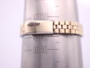 Close-up of the gold-toned Seiko bracelet on a wrist sizing gauge, showing a wrist circumference of 14.3cm.