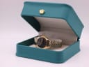 The vintage gold-toned Seiko watch nestled inside its original teal-coloured Seiko presentation box.