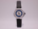 Front view of the Craftsman watch dial with blue and white bullseye pattern, presented on a clear watch stand.