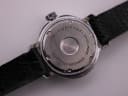 Detailed close-up of the Craftsman watch case back engraving, centred on the brushed stainless steel.