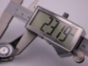 Digital caliper display showing the precise case diameter of the Craftsman watch as 23.19mm.