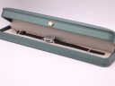 The Craftsman watch and its strap neatly presented inside its original rectangular green watch box.