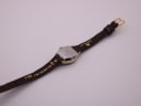 Rear view of the Citizen watch, focusing on the stainless steel case back and the brown leather strap with its texture.