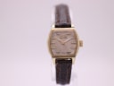 Front view of the Citizen 65-4329 watch, showing the gold-plated tonneau case and textured champagne dial on a stand.