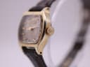 Right side profile of the Citizen watch, highlighting the gold-plated case, crown, and acrylic crystal.