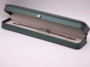 The Gucci 3900L watch presented in a generic green leatherette display box.