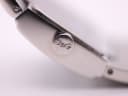 Extreme close-up of the watch crown, featuring the engraved D&G logo.