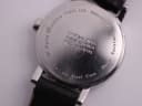 Detailed close-up of the stainless steel case back, showing 'MONDAINE Watch Ltd. Switzerland' and 'OFFICIAL SWISS RAILWAYS WATCH SBB CFF FFS' engravings, with some surface scratches.