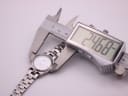 The Tissot PR 50 watch with a digital caliper displaying the case diameter of 24.68mm.