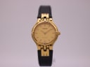 Front view of the Tissot Stylist watch, showing the gold dial, gold-tone case, and black leather strap.